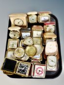 A tray of cased travel alarm clocks