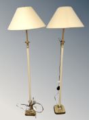 A pair of contemporary metal floor lamps on square brass bases with shades