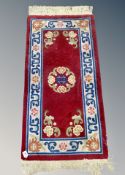 A Chinese rug on red ground,