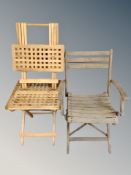 A folding wooden garden armchair together with two further folding teak lattice tables