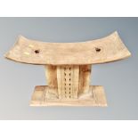 A Ghanaian ashanti stool, width 55 cm, height 40 cm, depth 23.5 cm.