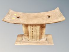 A Ghanaian ashanti stool, width 55 cm, height 40 cm, depth 23.5 cm.