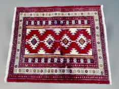 A Caucasian rug on red ground,