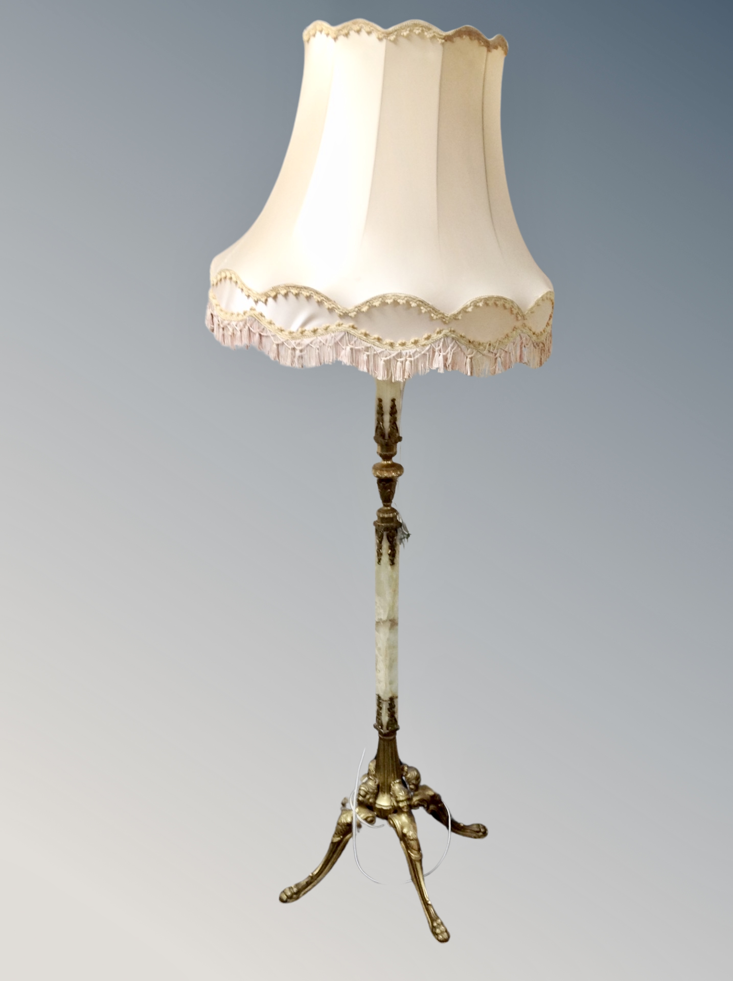 A gilt metal and onyx standard lamp with tasseled shade (af)