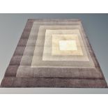 A contemporary brown and beige concentric square patterned rug,