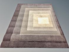 A contemporary brown and beige concentric square patterned rug,