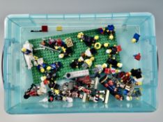 A small plastic storage box with lid containing vintage Lego mini figures,