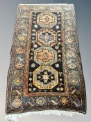 A Caucasian rug, 220cm by 126cm CONDITION REPORT: Loss to selvedge on one side.