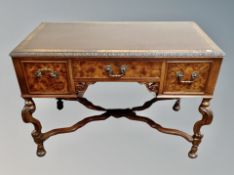 A reproduction burr walnut three drawer writing desk with leather inset panel , height 75 cm,