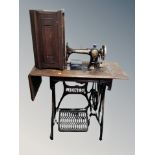 A vintage Jones treadle sewing machine in table