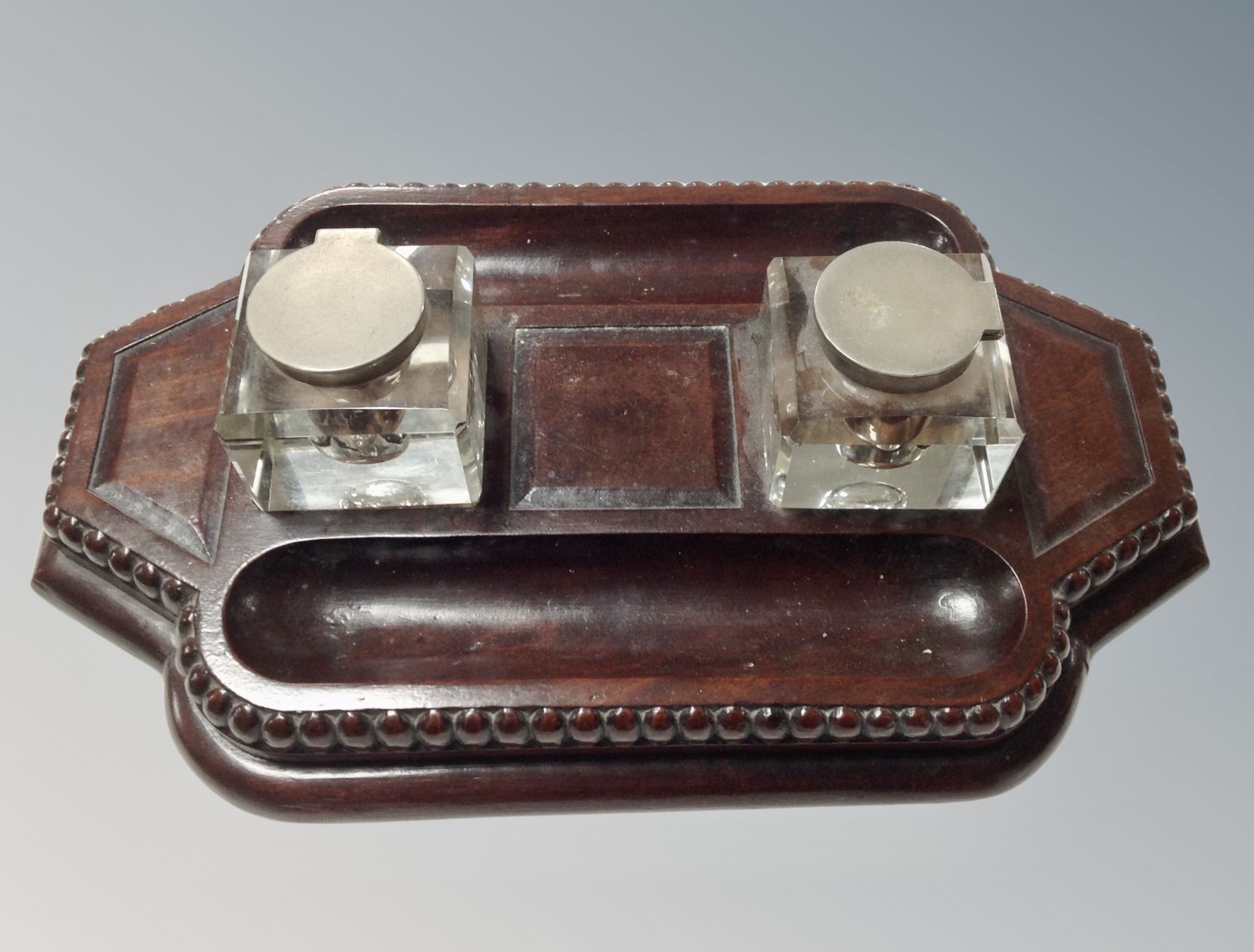 An Edwardian desk stand with glass inkwells