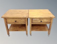 A pair of contemporary oak side tables fitted a drawer on castors