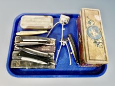 A vintage tin and a quantity of cut throat razors in cases,