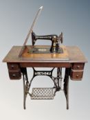 A vintage Singer treadle sewing machine in table