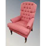 A Victorian style armchair in red buttoned fabric