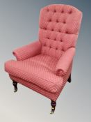 A Victorian style armchair in red buttoned fabric