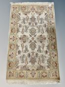 An Indian floral rug on cream ground,