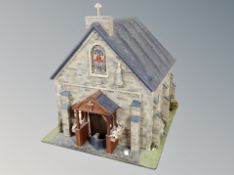 A church doll's building with fitted interior containing furniture and figures