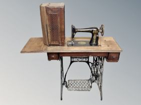 A vintage Singer treadle sewing machine in table