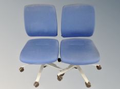 A pair of swivel adjustable office typists chairs in blue mesh fabric
