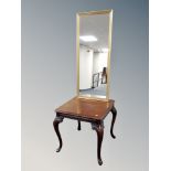 A contemporary square topped coffee table on cabriole legs together with a gilt hall mirror