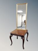 A contemporary square topped coffee table on cabriole legs together with a gilt hall mirror