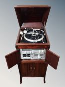 A mahogany gramophone cabinet containing Rotel RP 310 turntable,