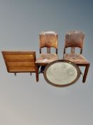 A pair of 19th century studded brown leather chairs together with an oak oval mirror and fire