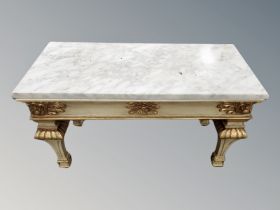 A cream and gilt low table with marble top,
