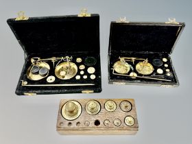 A group of graduated brass weights and precision scales