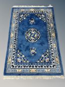 A Chinese fringed rug on blue ground 196 cm x 123 cm