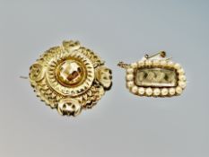 A 19th century oblong seed pearl mourning brooch and a further Etruscan Revival brooch.