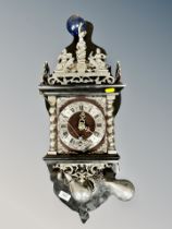 A Continental silvered wall clock with pear drop weights