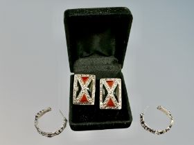 A pair of silver and enamel marcasite earrings and a further pair of silver hoop earrings.