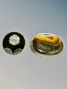 A silver and agate brooch, width 52mm, and a similar mother of pearl brooch.
