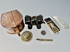 A pair of binoculars by Morreau of Paris together with a set of brass graduated weights,