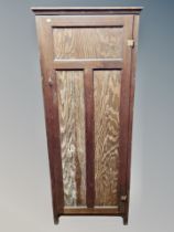 A stained pine sentry door pantry cupboard,