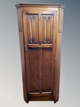 An oak linen fold sentry door wardrobe,
