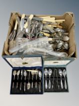 Two boxed cutlery sets and a collection of loose stainless steel and plated flatware