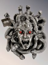 A contemporary Medusa wall plaque, 40cm high by 34cm wide by 10cm deep.