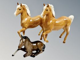 Two Beswick cantering Palomino horses together with a further foal and three Royal Doulton