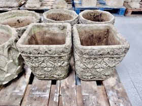 A pair of weathered concrete garden planters,