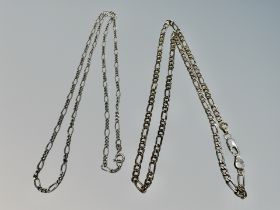 A silver figaro chain together with a further smaller link chain