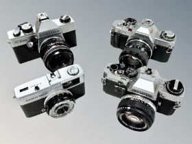 Four vintage cameras to include Olympus Tripp 35 and OM10 cameras,