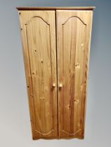 A contemporary pine double door wardrobe,