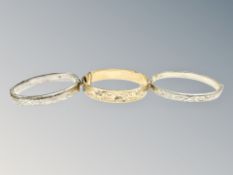 Two silver bangles and a further rolled-gold example.