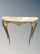 A gilt metal shaped console table with onyx top,