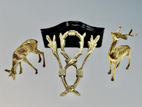 A brass and wood clock bracket and pair of brass figures of deer