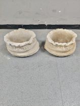 A pair of concrete sack planters height 25 cm