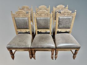 A set of six carved oak dining chairs in studded brown leather